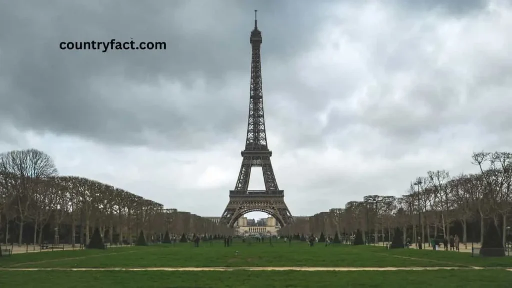 Tourists gathering at the base of the Eiffel Tower in Paris, France — one of the most popular spots related to interesting facts in France.